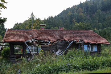 Old wooden house in disrepair on the edge of the village
