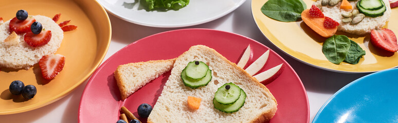 plates with fancy animals made of food for childrens breakfast on white background