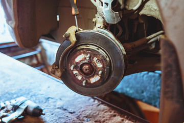 Car hub with brake disc in a workshop - auto repair shop