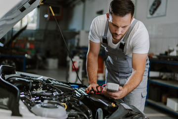 Auto mechanic working on car diagnostic in a repair shop