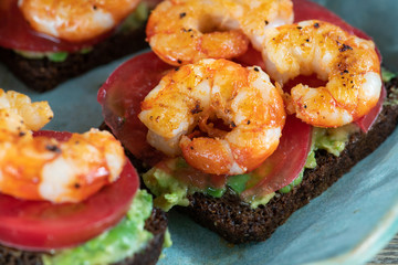 Grilled shrimps on guacamole toasts