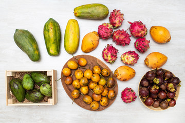 Beautiful composition of tropical fruits: papaya, coconuts, dragon fruit, passion fruit, avocado and mangosteens