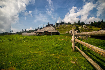 Fototapeta na wymiar High plateau of Velika Planina, land of pastures and alpine huts high in the mountains, Slovenian Alps