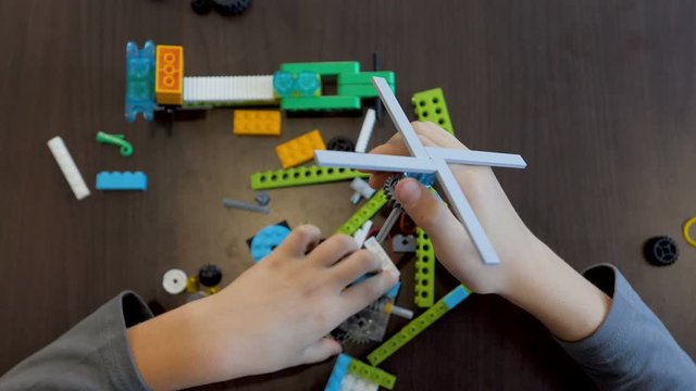 Children in the classroom make figure from the designer