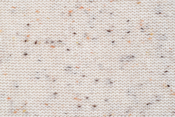 Beige melange fabric knitted texture background. Cotton jersey. Purl, reverse loop