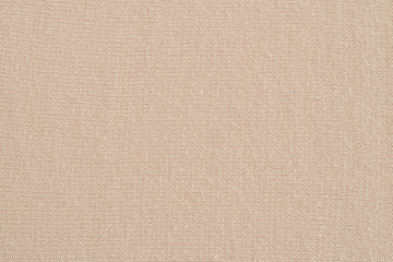 Beige knitted fabric texture. Soft jersey background. 