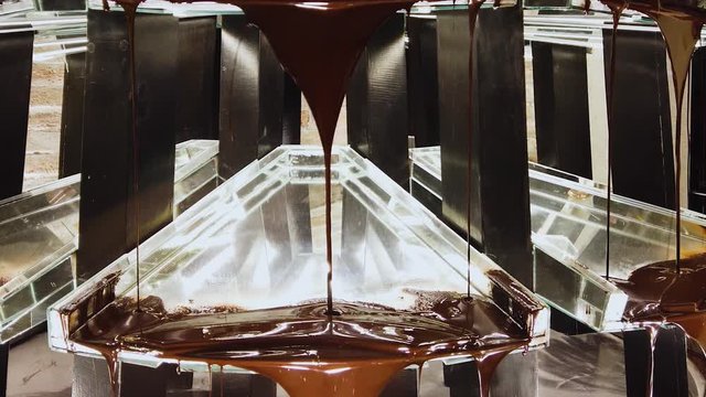 Hot chocolate liquid falling from top to bottom of the screen. Royalty free stock footage related to food, travel, lifestyle, diet, dream, special event.
