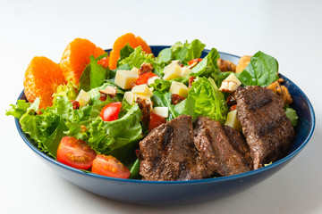 Delicious meat salad with roast beef, mushrooms and vegetables.Tasty meat salad. White background.