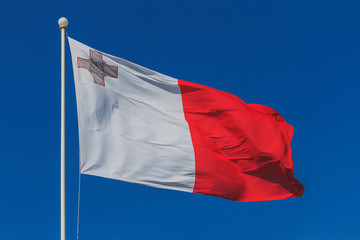 Malta national flag is waving in deep blue sky background