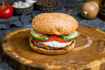 Burger with egg and beef and vegetables