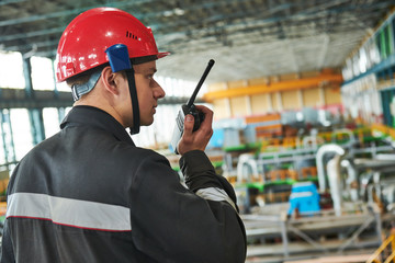 industrial worker on power plant factory with walkie talkie transmitter