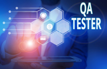 Fototapeta premium Conceptual hand writing showing Qa Tester. Concept meaning Quality assurance of an on going project before implementation Male wear formal suit presenting presentation smart device