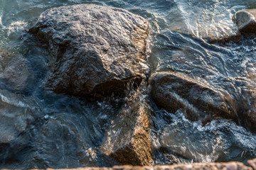 Rocks in the water of the lake or the sea