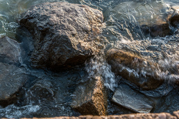 Rocks in the water of the lake or the sea