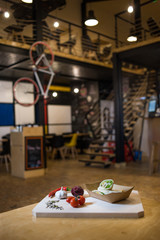 Appetizing fast food on a wooden board with fresh vegetables.