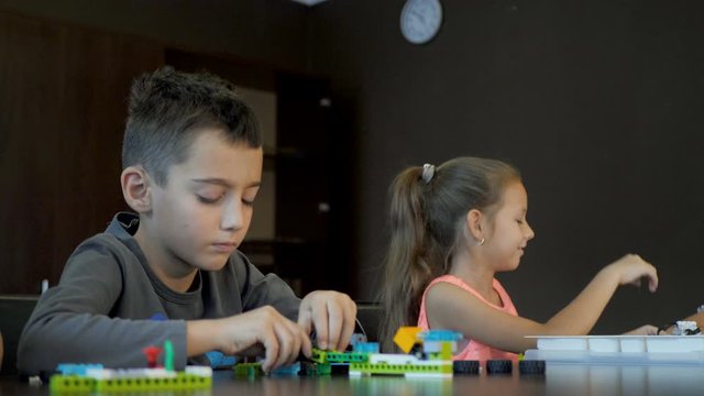 Children in the classroom make figure from the designer