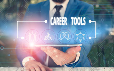 Fototapeta premium Writing note showing Career Tools. Business concept for the system designed to assist and enhance your career Male wear formal work suit presenting presentation smart device