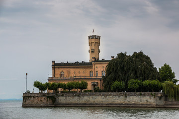 Little castle with round tower near the lake