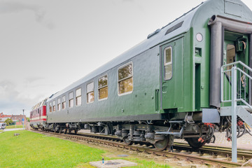 an old historical train of the Deutsche Reichsbahn from the times of the GDR stands on a siding