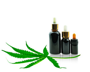Bottle with CBD oil and cannabis leaf at white background, medical marijuana concept