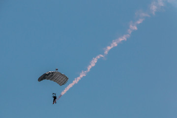 German skydiver in the air with a tail of smoke