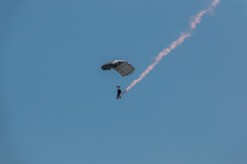 German skydiver in the air with a tail of smoke
