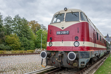 an old historical train of the Deutsche Reichsbahn from the times of the GDR stands on a siding