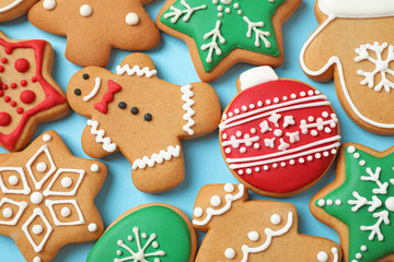 Flat lay composition with tasty homemade Christmas cookies on light blue background
