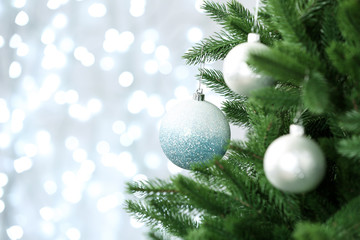 Decorated Christmas tree against blurred lights on background. Bokeh effect