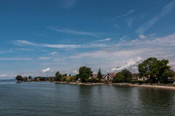 Fototapeta premium Little spit of land into the water and a little village