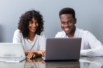 Two Businesspeople Working On Laptop Computer