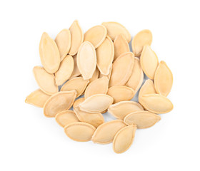 Pile of raw pumpkin seeds on white background, top view