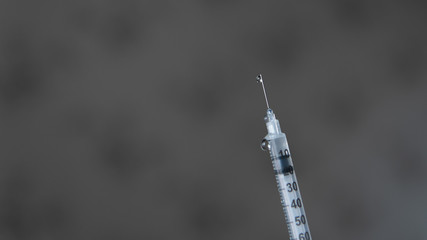 drops of medicine are sprayed out of the syringe