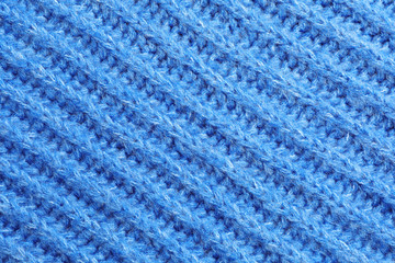 Blue winter sweater as background, closeup view