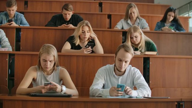 Students chat online in a university classroom. Introverts and fear of people