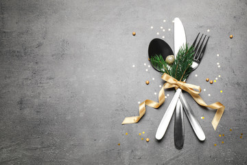 Cutlery set on grey table, flat lay. Space for text