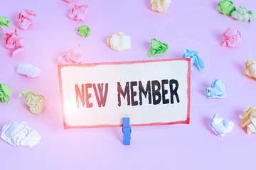 Conceptual hand writing showing New Member. Concept meaning recruiting employee to company or team Birth of fresh child Colored crumpled papers empty reminder pink floor clothespin