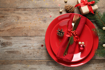 Beautiful Christmas table setting on wooden background, top view. Space for text