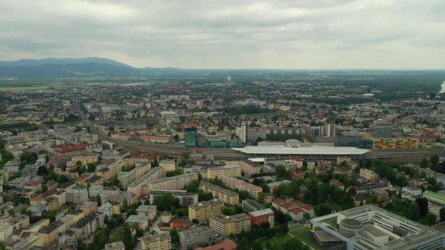flight over salzburg city train station traffic district day time aerial panorama 4k austria