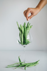 fresh green beans in glass. green beans isolated on a white background hand holding fresh green beans in glass