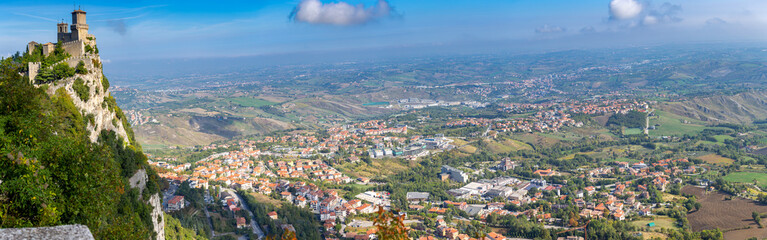 Fototapeta na wymiar San Marino. Panorama of old stone towers on the top of the mountain.