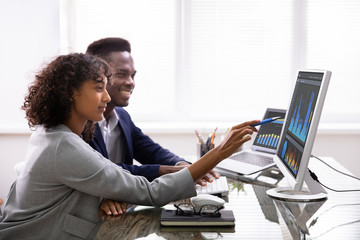 Stock Market Broker Analyzing Graphs On Computer