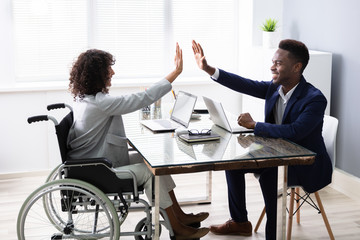Disabled Businesswoman Giving High Five To His Partner
