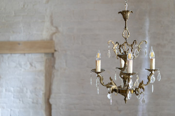 Crystal chandelier lamp against white wall with copy space