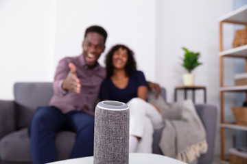 Close-up Of Wireless Speaker In Front Of Couple