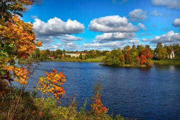 Idyllic autumn landscape with lake and dramatic clouds. 