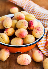 Fresh ripe apricots on wooden rustic background