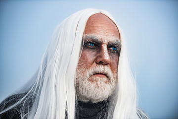 Happy Halloween - handsome Demon isolated on dark background. Bearded man dressed like Halloween...