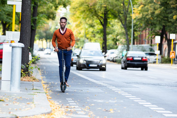 Young Man Riding An Electric Scooter