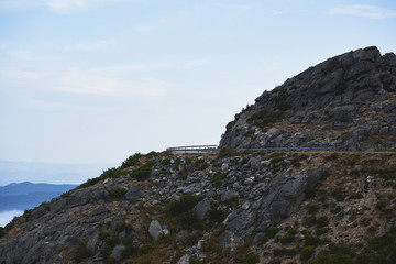 Natural Park of Alvão view. Rustic roud on the mountain with a scenic landscape on the background. Daylight. Mondim de Bastos, Portugal                              